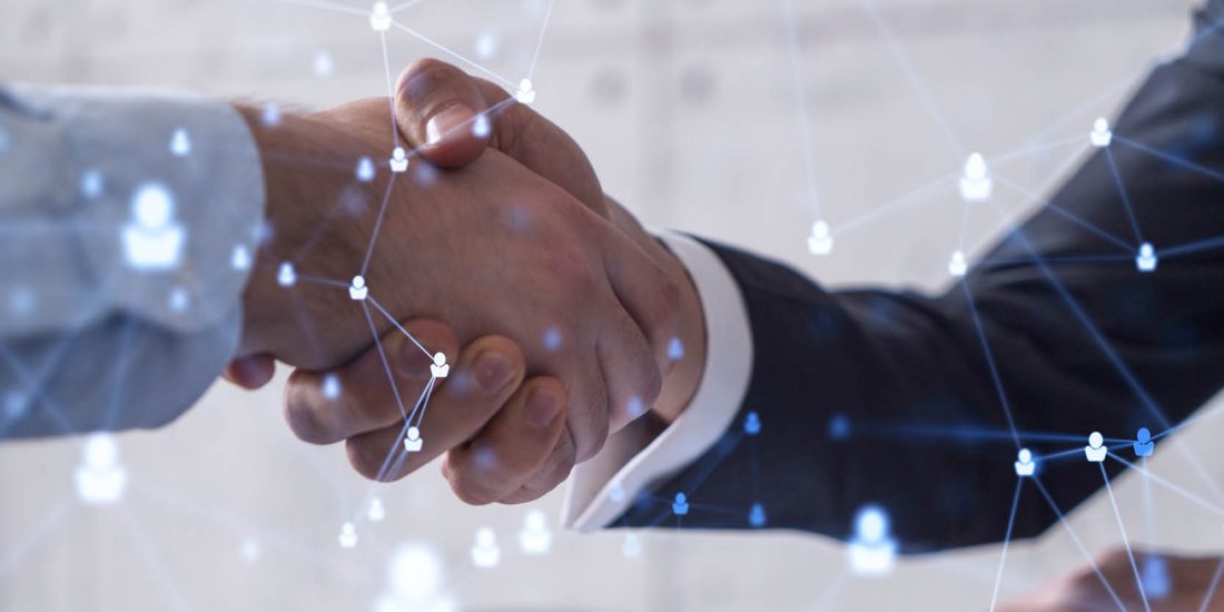 close up 2 hands shaking eachother