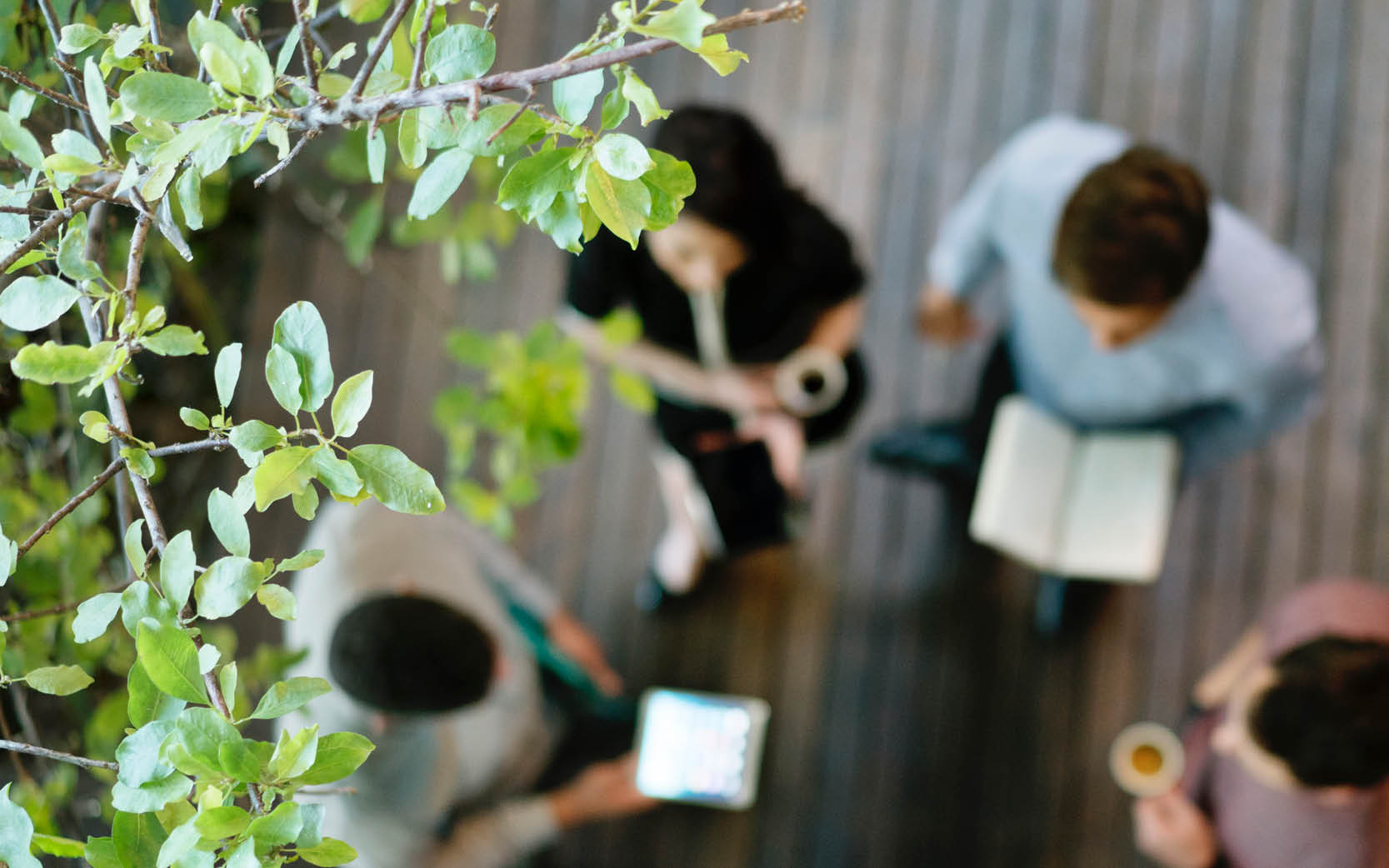 blurred shot of workers having stand up meeting