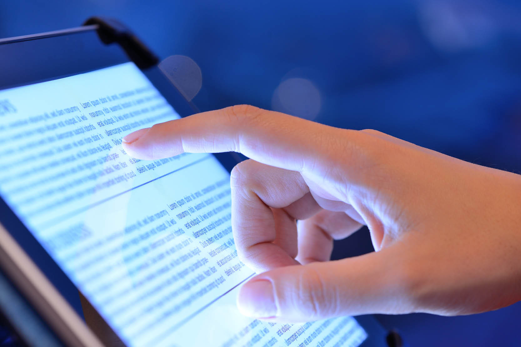 close up- finger on hand pointing to screen text